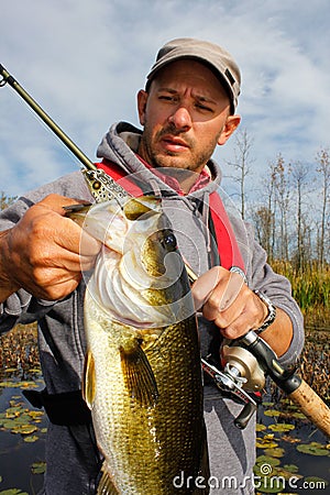 Man Fishing Large Mouth Bass Stock Photo