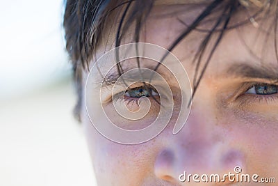 The man on beach, squinting from the sun Stock Photo