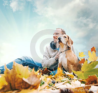 Man with beagle on autumn view landscape Stock Photo