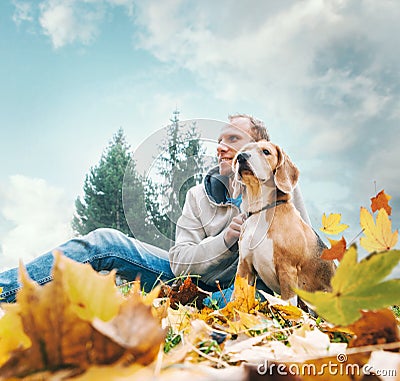 Man with beagle on autumn view landscape Stock Photo