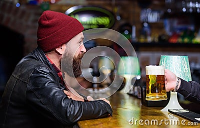 Man with beard spend leisure in dark bar. Brutal lonely hipster. Brutal hipster bearded man sit at bar counter. Friday Stock Photo