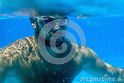 Man with Beard Underwater swimming pool Young beard man with glasses Underwater Stock Photo