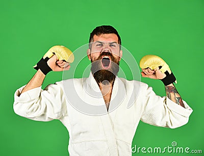 Man with beard in white kimono on green background Stock Photo