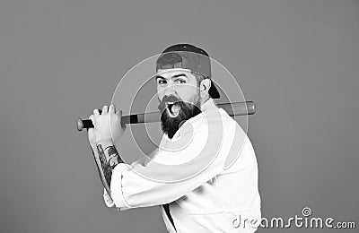 Man with beard in white kimono and green cap on blue background. Gangster gets ready to fight. Violence and bullying Stock Photo