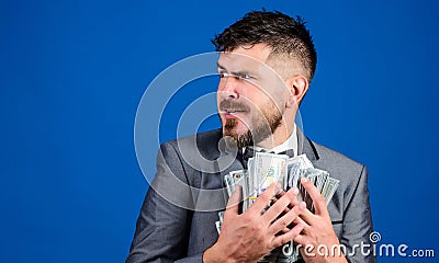Man bearded businessman hold pile money blue background. Businessman surprised feels like thief with lot of cash in Stock Photo