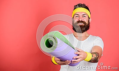 Man bearded happy athlete hold mat red background. Athlete coach ready for training. Old school aerobics concept Stock Photo