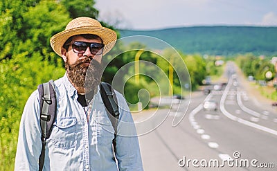 Man bearded hipster backpacker at edge of highway. Take me with you. Traveler waiting for car take him anyway just to Stock Photo