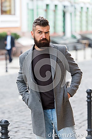 Man bearded hipster casual style waiting for taxi. Guy at street city center. Looking for transportation. Bus stop. Taxi Stock Photo