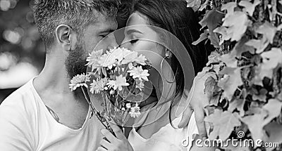 Man bearded hipster kisses girlfriend. Secret romantic kiss. Love romantic feelings. Moment of intimacy. Couple in love Stock Photo