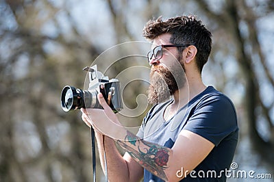 Man bearded hipster photographer hold vintage camera. Photographer with beard and mustache amateur photographer nature Stock Photo