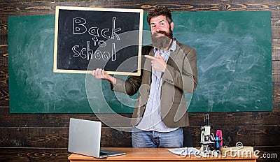 Man bearded holds blackboard inscription back to school. Hiring teachers for new school year. Looking committed teacher Stock Photo