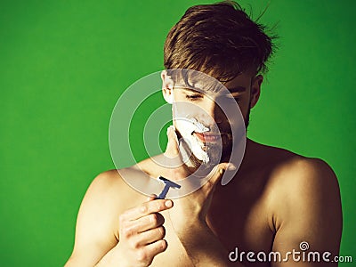 Man shaving beard hair with safety razor and foam Stock Photo