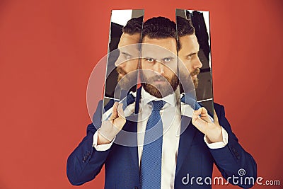 Man, bearded serious businessman reflecting in mirror Stock Photo