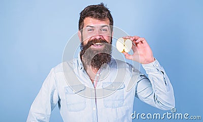 Man bearded smiling holds apple blue background. Healthcare dieting vitamin nutrition. Half of apple healthy lifestyle Stock Photo