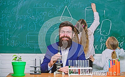 Man bearded teacher work with microscope and test tubes in biology classroom. Biology plays role in understanding of Stock Photo