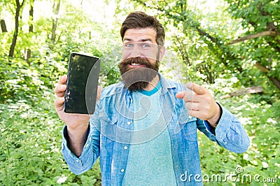 Man bearded wanderer walking in forest with navigation application. Hiking with navigation app. Route for exciting Stock Photo