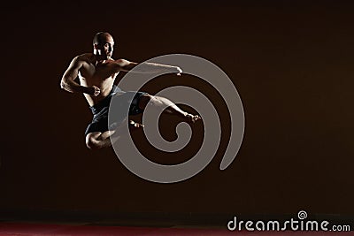 The man beats a kick in the jump to the side Stock Photo