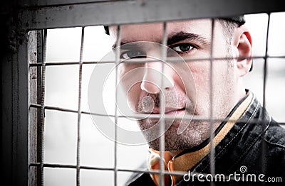 Man Behind An Iron Lattice Stock Photo