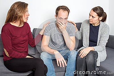 Man being sad in living room Stock Photo