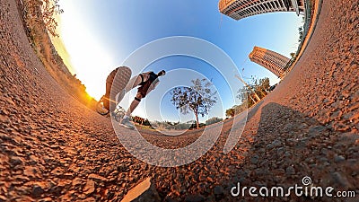 Man with bicycle on little on a park with trees, soft blue sky and sunset. Outdoor dramatic of man with mask in a park and Stock Photo