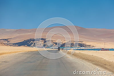 Man on bicycle , Paracas National Reserve desert, Pisco, Peru 2019-12-05. Editorial Stock Photo