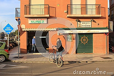 Man with a bicycle, street photo from Malaga, Spain Editorial Stock Photo