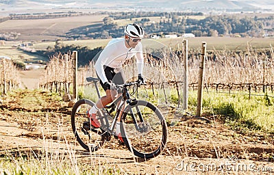 Man, bike and cycling on gravel in nature, countryside and training of triathlon, sports and power. Cyclist, bicycle and Stock Photo