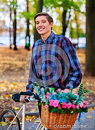 Man on bike with flowers basket in park Stock Photo