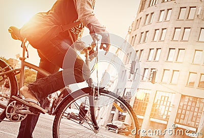 Man on bike in traffic with sunflare Stock Photo