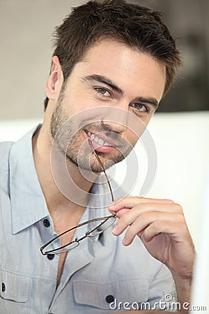 Man biting his glasses Stock Photo