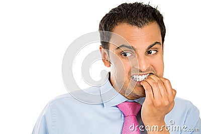 Man biting his nails and looking to the side with a craving for something or anxious Stock Photo