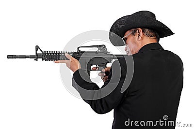 Man in black shooting with rifle Stock Photo