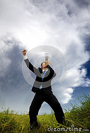 Man in the black suit and holding megaphone shouti Stock Photo