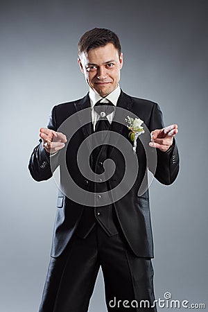 Man in black suit pointing fingers in front Stock Photo