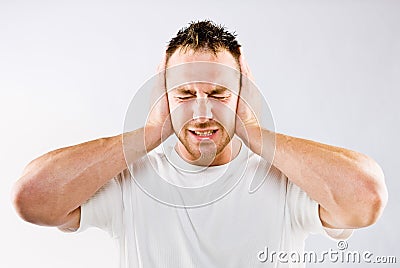 Man blocking out loud noise from ears Stock Photo