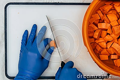 A man in blue gloves near to a food Stock Photo