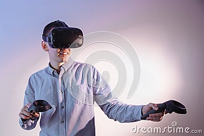 A man in blue jeans with BP glasses and with sticks in his hands is passionate about the 3D game Stock Photo