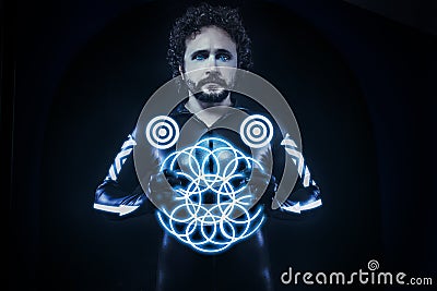 Man with blue neon lights, the future warrior costume, fantasy s Stock Photo