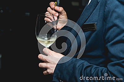 Man holds glass of wine. people consider the color of the wine and try how it smells in different glasses Stock Photo