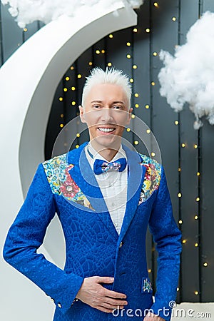 A man in a blue suit smiles with white hair suit blue studio success standing, for businessman shirt in job elegance Stock Photo