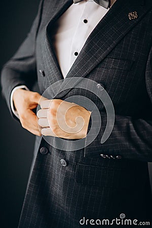 A man in a blue suit zips up his jacket, close-up. Businessman changing clothes.Tonal correction. FASHION, STYLE Stock Photo