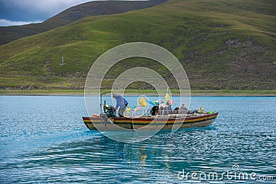 Man on a boat in Yamdrok lake Editorial Stock Photo