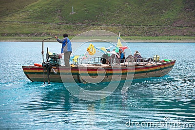 Man on a boat in Yamdrok lake Editorial Stock Photo