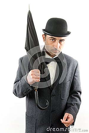 Man with bowler hat and an umbrella Stock Photo