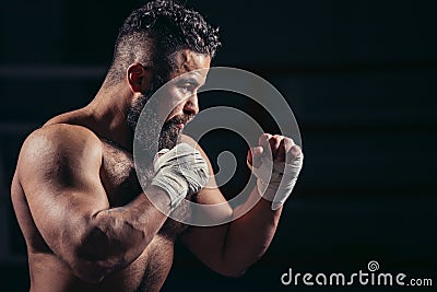 Man boxing workout on ring. Caucasian male boxer in black gloves Stock Photo