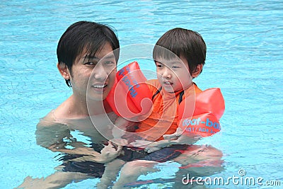 Man and boy in the pool Stock Photo