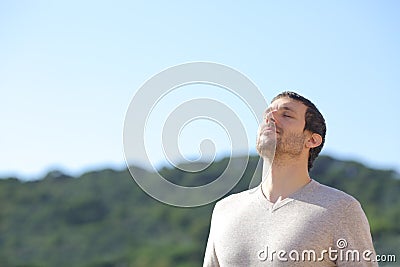 Man breathing fresh air near the mountains Stock Photo