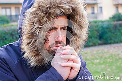 Man dressed in warm clothing to protect himself from cold weather Stock Photo