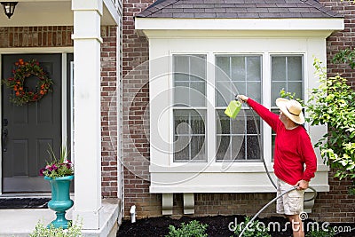 Man washing the bump-out or bay windows Stock Photo