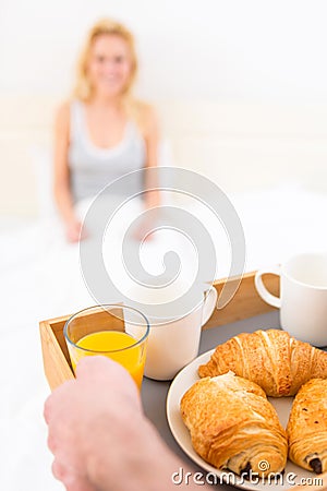 http://thumbs.dreamstime.com/x/man-bringing-young-attractive-woman-breakfast-bed-view-47433154.jpg